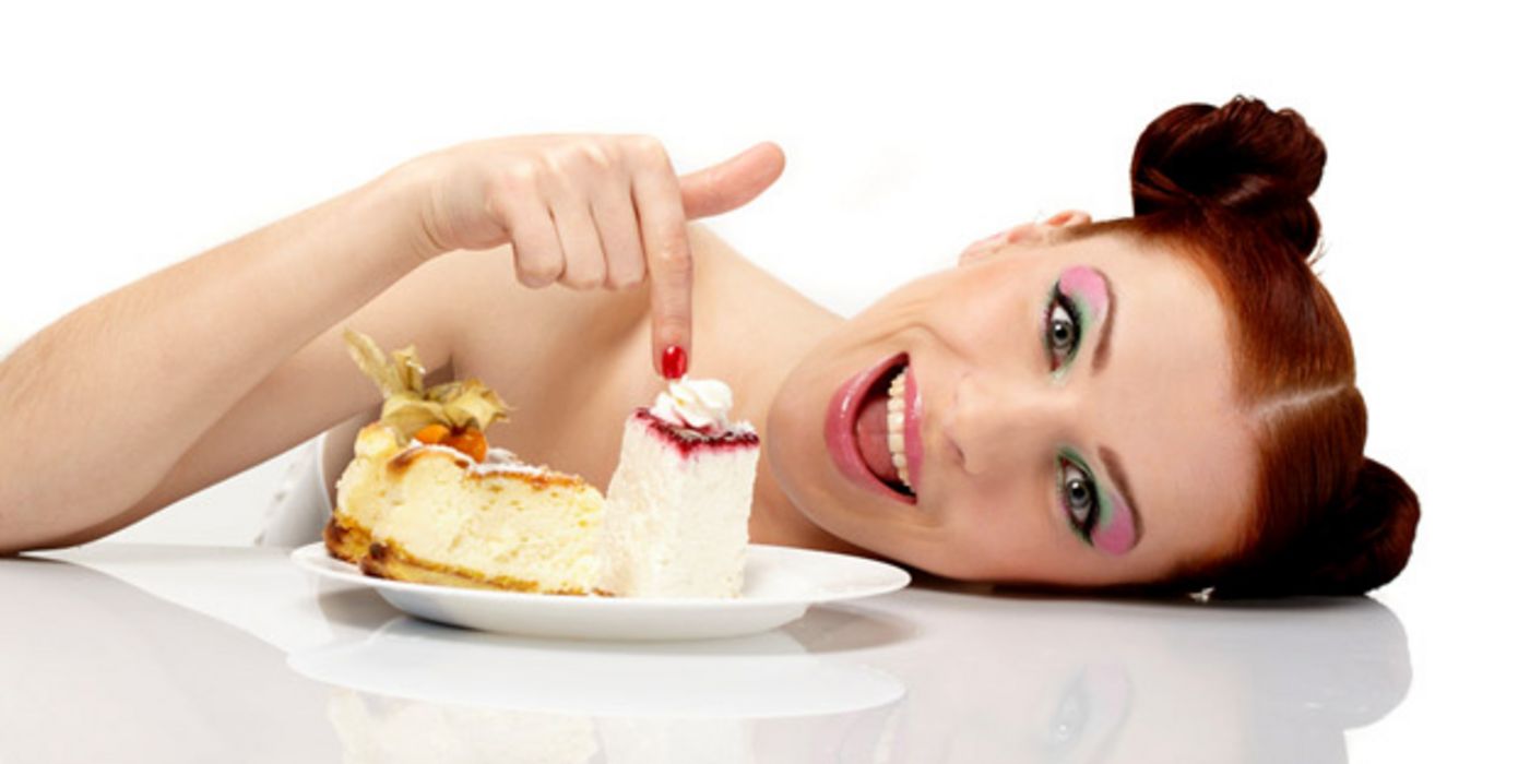 Junge Frau vor einem Teller mit Torte