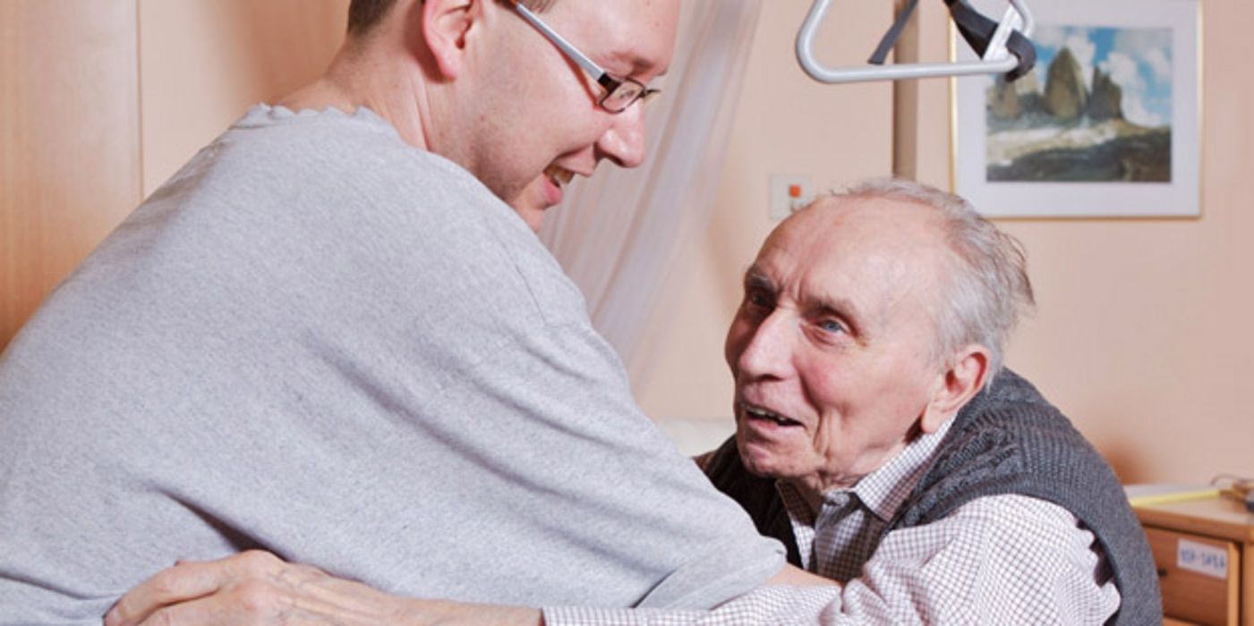 Pfleger hilft altem Mann