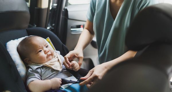 Baby in einem nach hinten gerichteten Autositz.