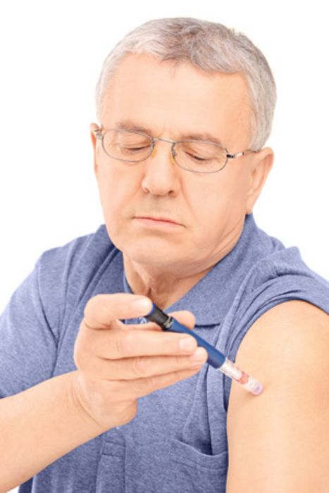 Älterer Mann spritzt sich Insulin in den Oberarm.