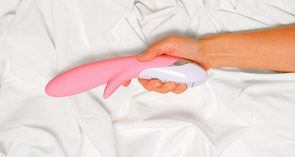 Frau, hält einen Vibrator in der Hand.