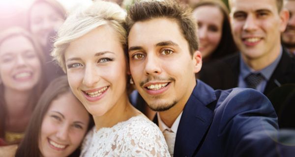 Selfie mit attraktiven jungen Menschen, Frau und Mann im Mittelpunkt