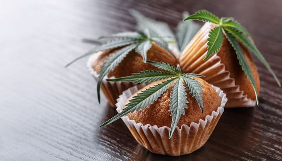 Muffins, auf denen Cannabisblätter liegen.