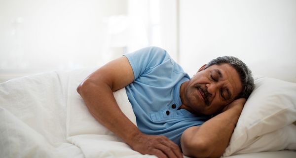 Mann, liegt im Bett schläft. 