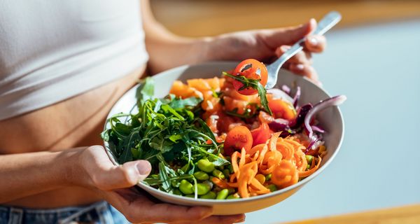 Frau mit einer großen Bowl mit Gemüse.