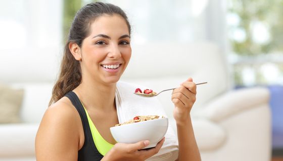 Junge Frau isst Müsli