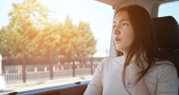 Frau, ist im Auto übel.