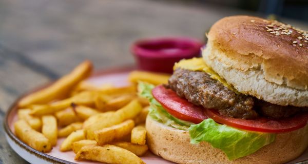 Burger und Pommes auf einem Tisch.