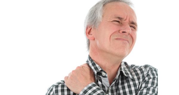 Mittelalter Mann im grau-weiß karierten Hemd greift sich mit schmerzverzerrter Miene an die linke Schulter