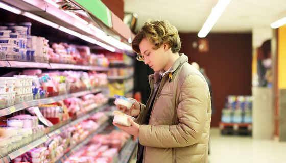 Junger Mann, betrachtet Lebensmittel im Supermarkt.