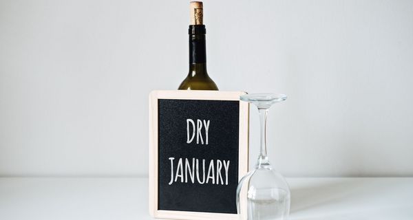Schild mit der Aufschrift "Dry January" und einem umgekipptem Weinglas.