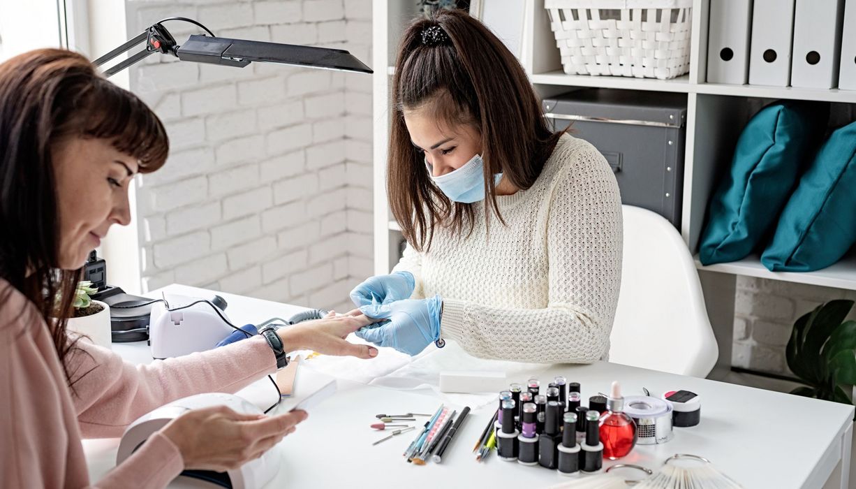 Frau, im Nagelstudio, lässt sich die Nägel machen.