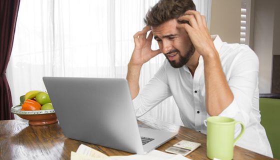 Junger gestresster Mann vor dem Computer.