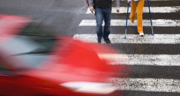 Auto und Fußgänger am Zebrastreifen