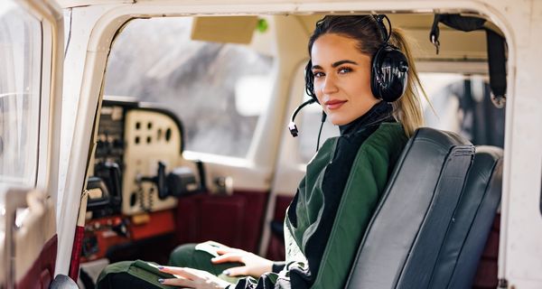 Pilotin, sitzt im Cockpit.
