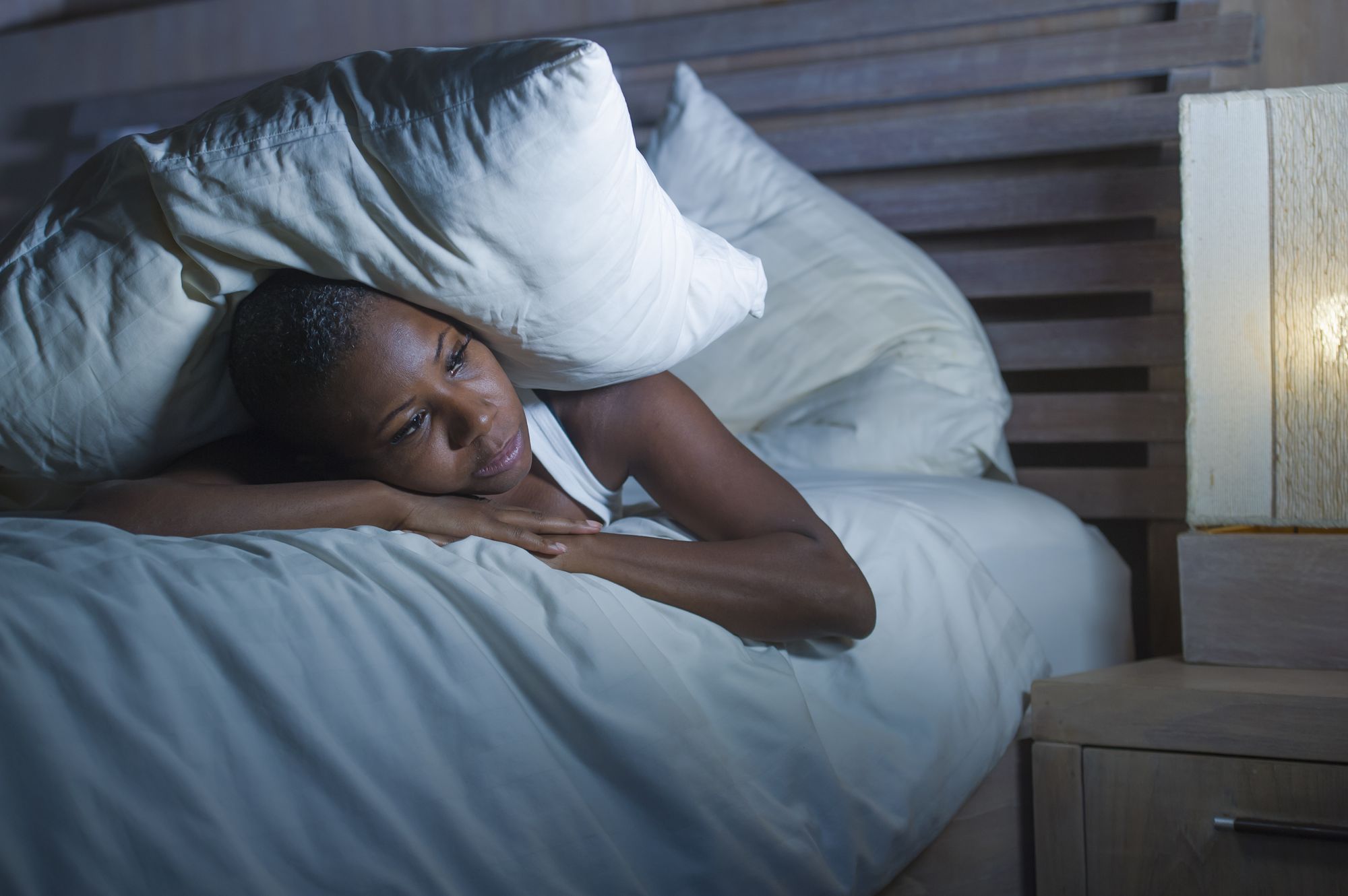 Ältere Frau, liegt im Bett und kann nicht schlafen.